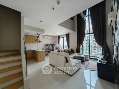 Spacious modern living room with high ceilings and city view