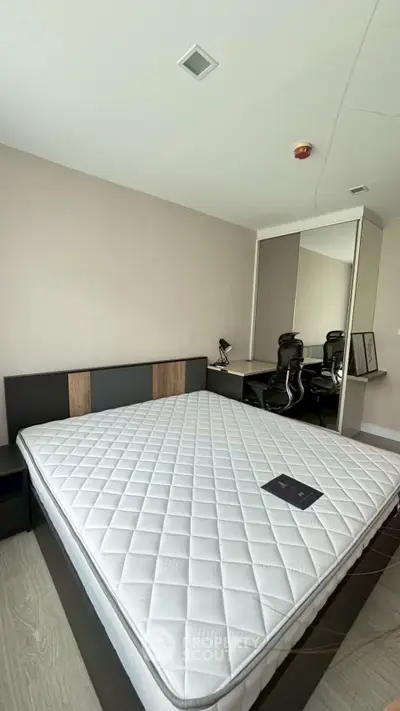 Modern bedroom with sleek design and large mirror wardrobe
