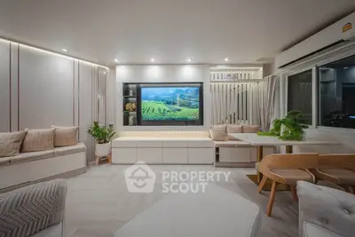 Modern living room with sleek design, built-in TV, and stylish furniture, perfect for relaxation and entertainment.
