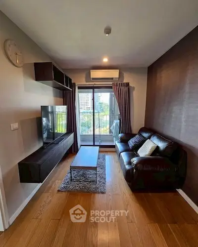 Modern living room with sleek furniture and city view balcony