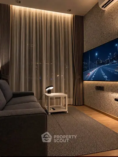 Modern living room with stylish decor and large TV, perfect for entertainment and relaxation.