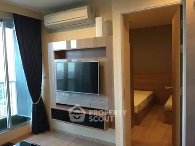 Modern living room with wall-mounted TV and adjacent bedroom view