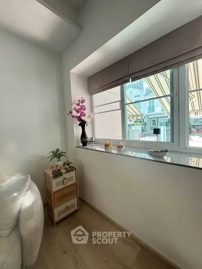 Cozy corner with large window and elegant decor in modern apartment