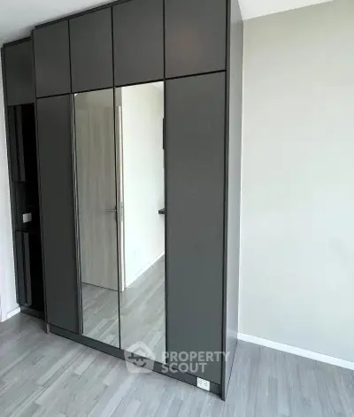 Modern bedroom with sleek built-in wardrobe and minimalist design