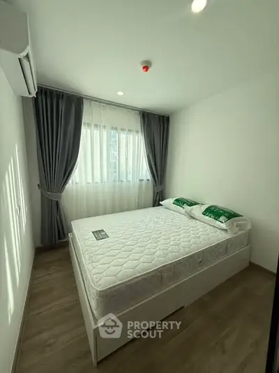 Bright and cozy bedroom with modern decor and ample natural light.