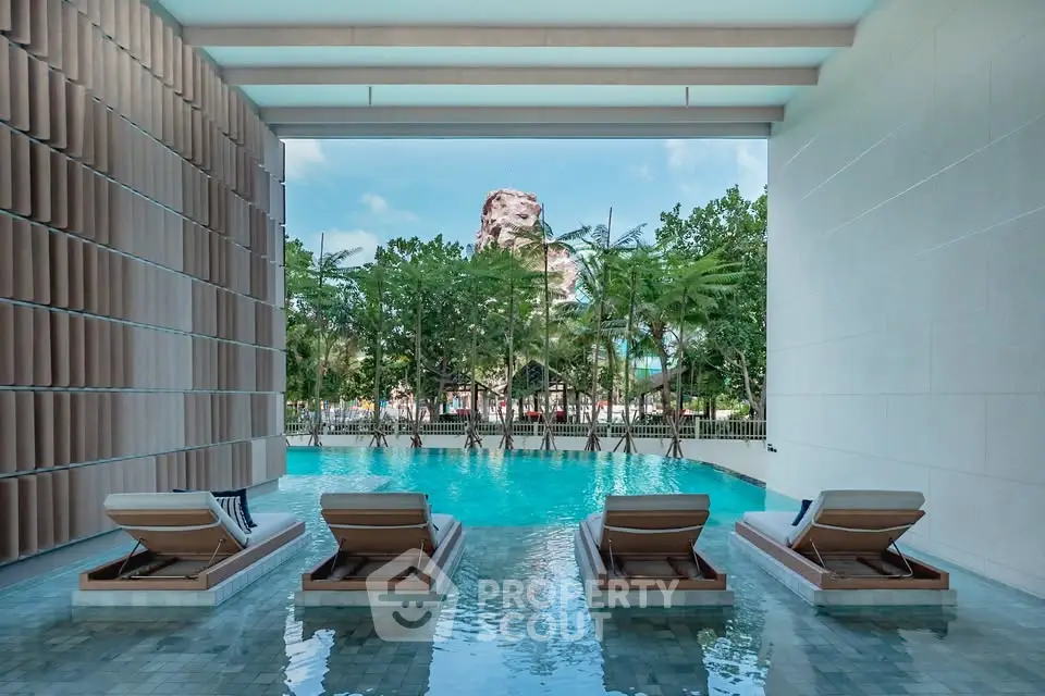 Luxurious poolside view with modern loungers and tropical backdrop