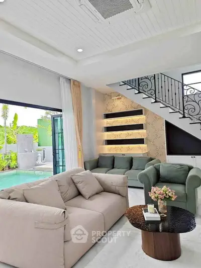 Luxurious living room with pool view and elegant staircase in modern home