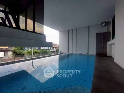 Luxurious indoor pool with modern design and city view, perfect for relaxation and leisure.