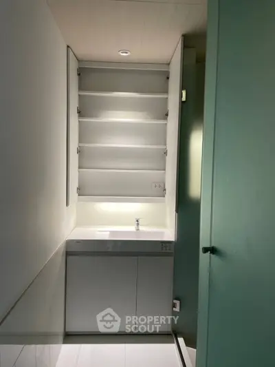 Modern minimalist bathroom with sleek white cabinetry and ambient lighting