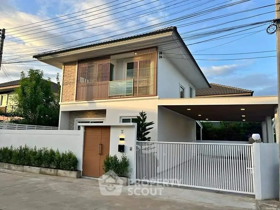 Modern two-story house with sleek design and spacious driveway in a serene neighborhood.