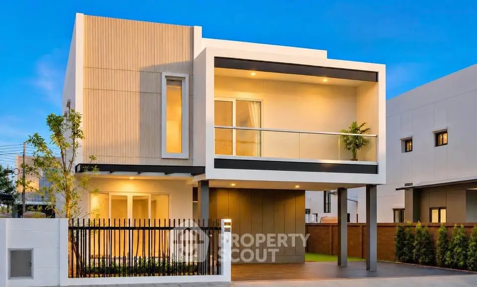 Modern two-story house with sleek design and spacious balcony, perfect for contemporary living.