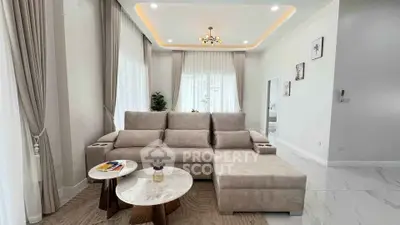 Elegant living room with modern sofa, chic lighting, and stylish decor in a bright, airy space.