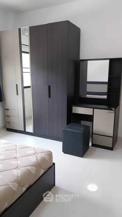 Modern bedroom with sleek wardrobe and stylish vanity set