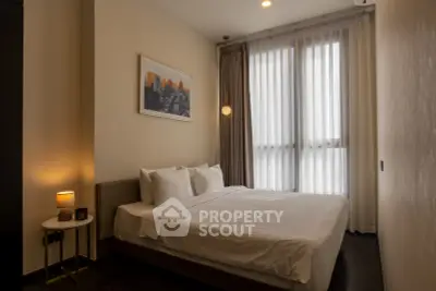 Elegant bedroom with large window and modern decor in luxury apartment