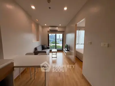 Modern living room with wooden flooring and city view in a stylish apartment