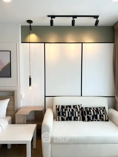 Modern living room with stylish lighting and cozy white sofa