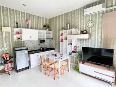 Charming kitchen and living area with modern decor and appliances, perfect for cozy living.