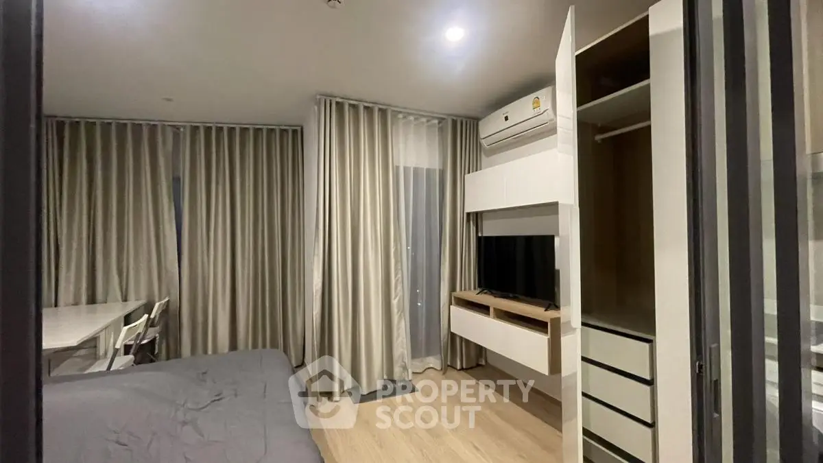 Modern bedroom with built-in storage and air conditioning in stylish apartment