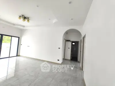 Spacious modern living room with elegant lighting and large windows