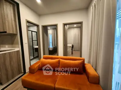 Modern apartment interior with vibrant orange sofa and stylish decor