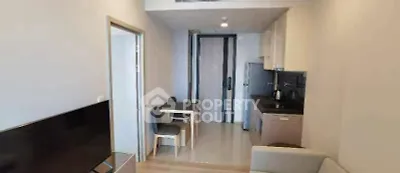Modern compact apartment interior with open kitchen and cozy living area