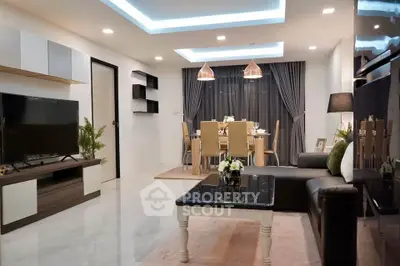 Modern living room with stylish dining area, featuring sleek furniture and ambient lighting.