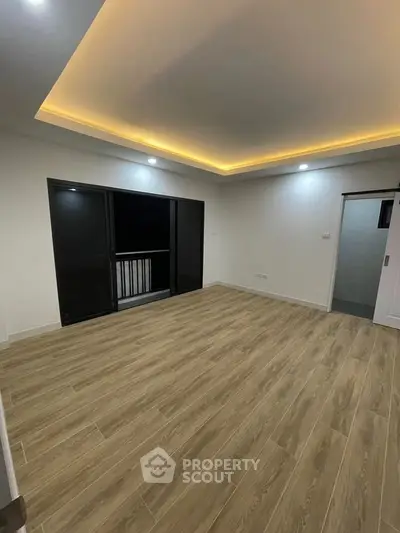 Modern living room with wooden flooring and recessed lighting