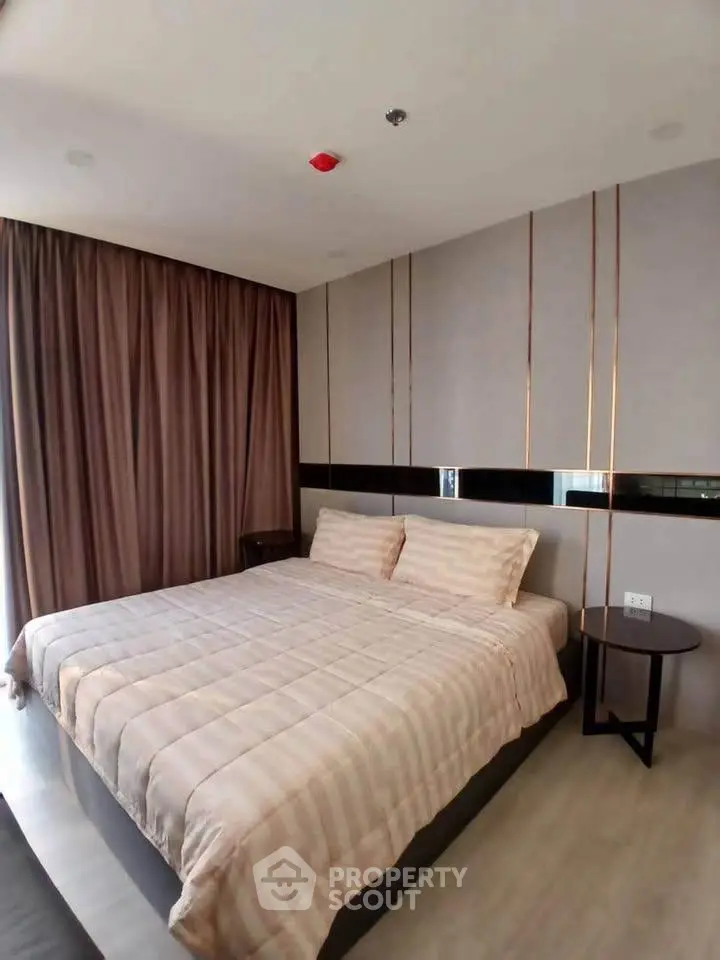 Spacious bedroom with modern decor and large bed in a stylish apartment.