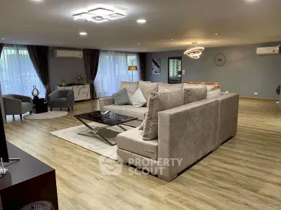 Spacious modern living room with elegant decor and large windows for natural light.