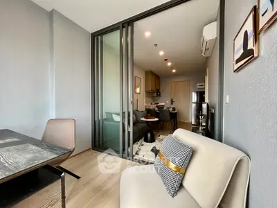 Modern open-plan living room with stylish decor and sliding glass doors