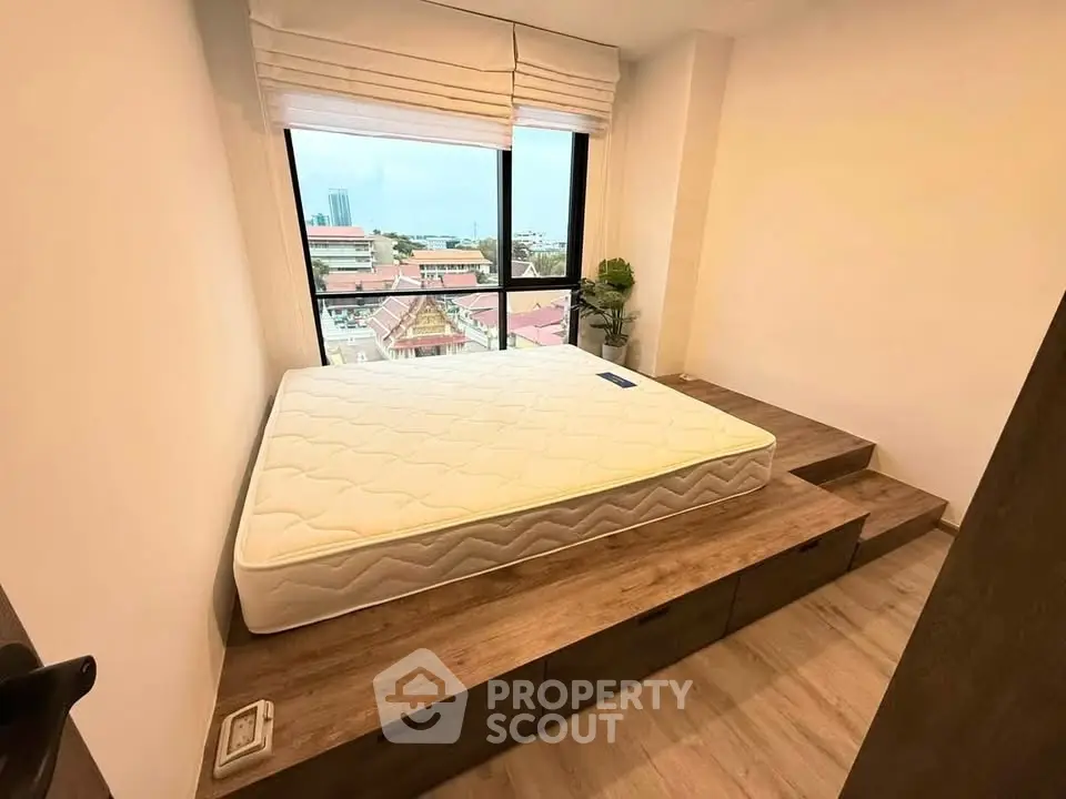 Modern bedroom with platform bed and city view window