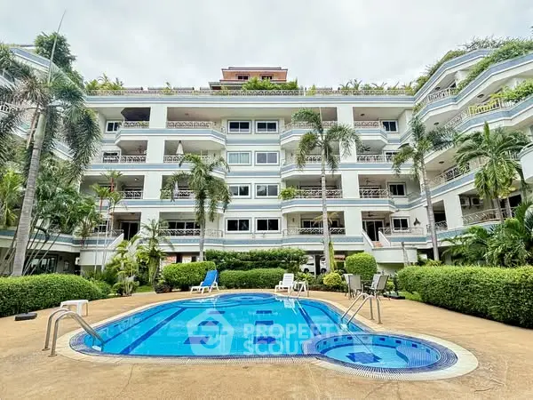 Luxurious residential building with pool and lush greenery, perfect for relaxation and leisure.