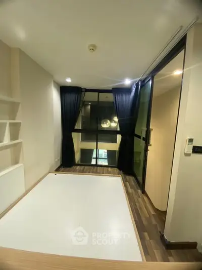 Modern interior with large windows and wooden flooring, perfect for cozy living.