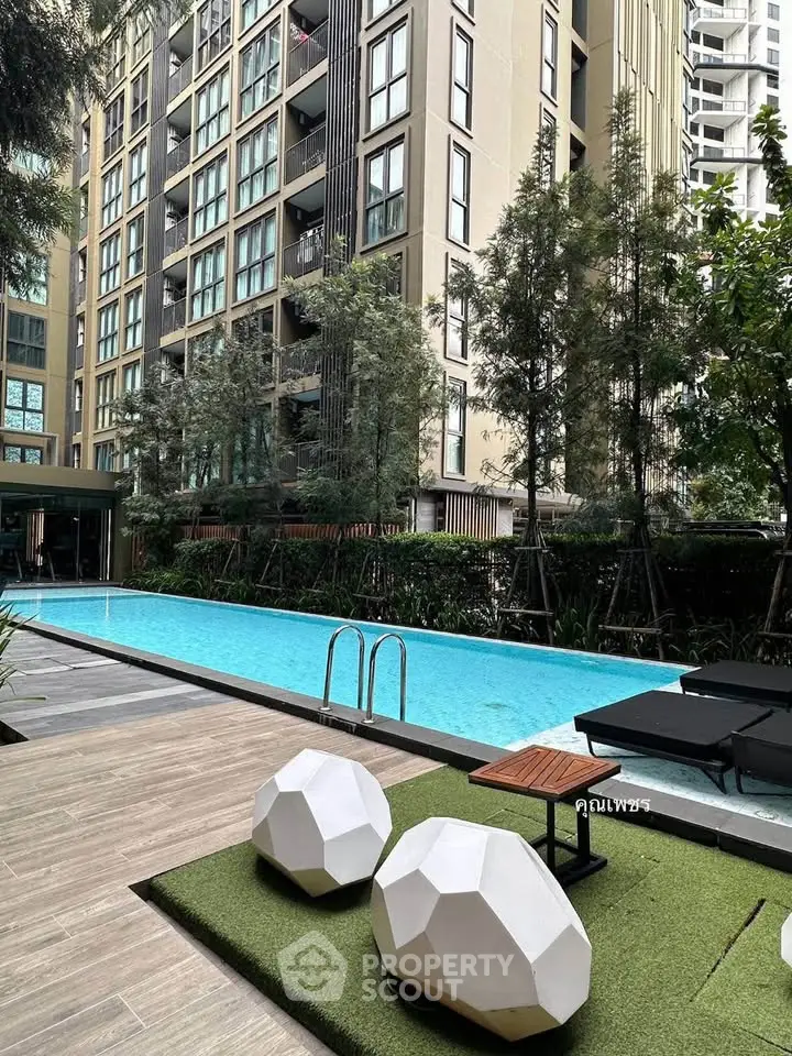 Luxurious condominium with modern pool and lush greenery in urban setting