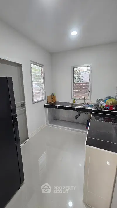 Modern kitchen with sleek black countertops and stainless steel appliances