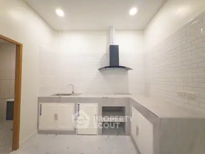 Modern kitchen with sleek white cabinetry and stylish backsplash