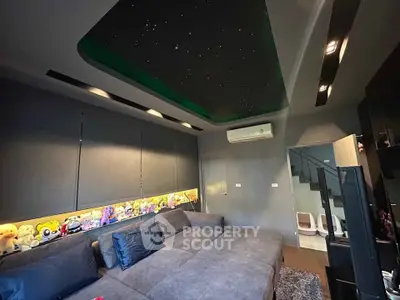 Luxurious living room with plush seating and starry ceiling, perfect for relaxation and entertainment.