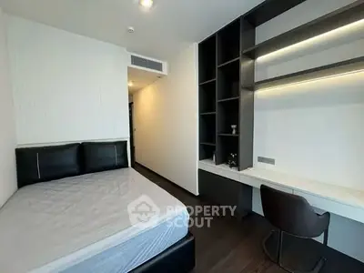 Modern bedroom with sleek design and built-in study area, perfect for urban living.