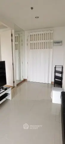 Modern living room with sleek design and mirrored wall for spacious feel