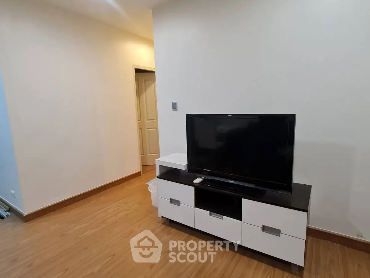 Modern living room with sleek TV stand and wooden flooring