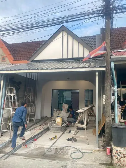 Charming single-story house under renovation with modern facade and pitched roof.