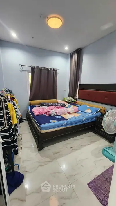 Cozy bedroom with modern decor and ample natural light