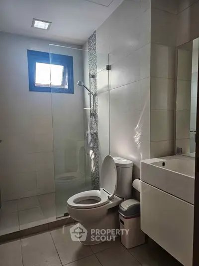Modern bathroom with sleek shower and contemporary fixtures, perfect for a stylish home.