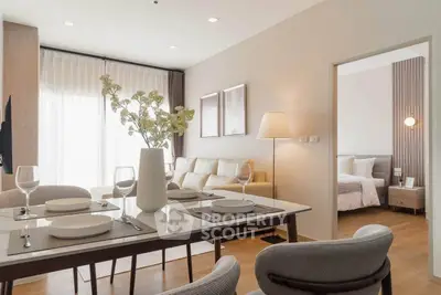 Modern open-plan living and dining area with elegant decor and natural light.
