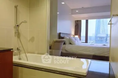 Modern apartment with a luxurious bathroom and stunning city view from the bedroom.
