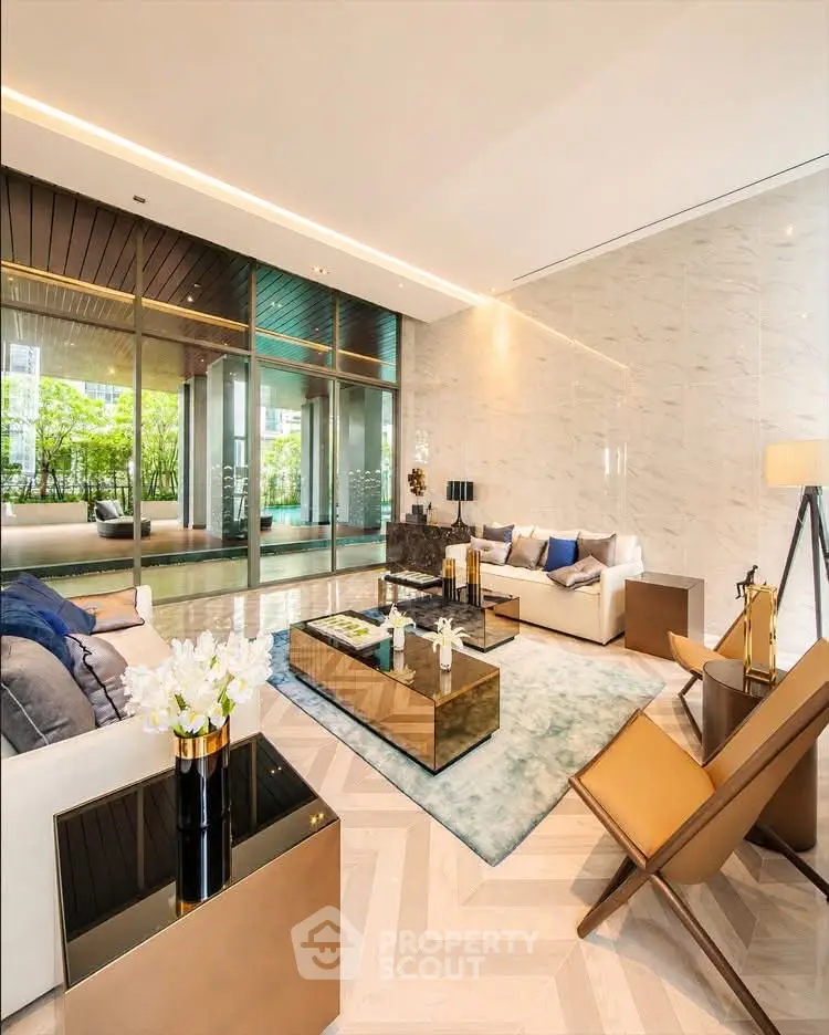 Luxurious living room with modern decor, floor-to-ceiling windows, and elegant furniture overlooking a lush garden.