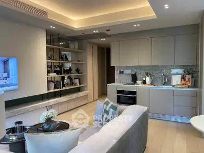 Modern open-layout living room and kitchen with sleek design and cozy ambiance.