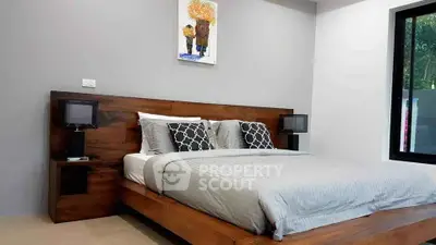 Modern bedroom with stylish wooden bed frame and elegant decor