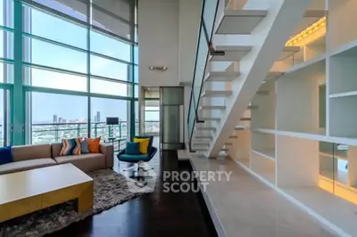 Luxurious modern living room with high ceilings and stunning city view.
