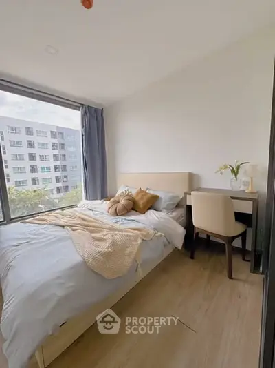 Cozy bedroom with large window and modern decor in urban apartment